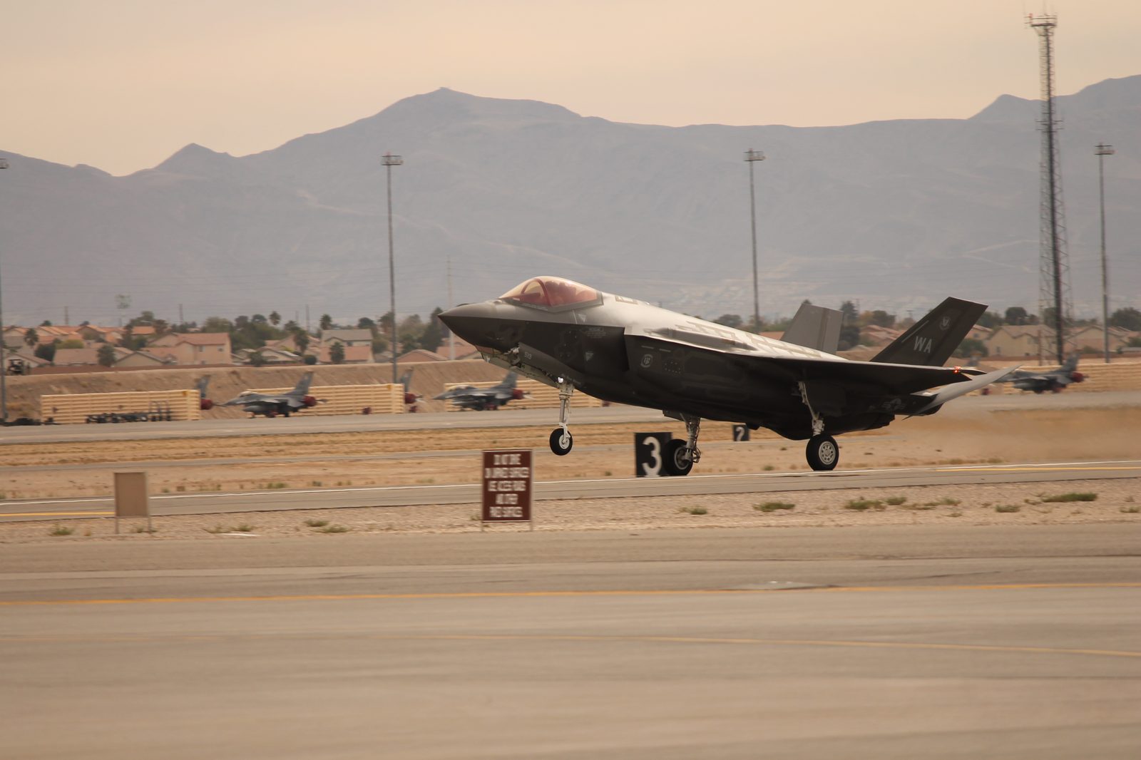 An F-35A Lightning II landing, full profile, landing gear extended.