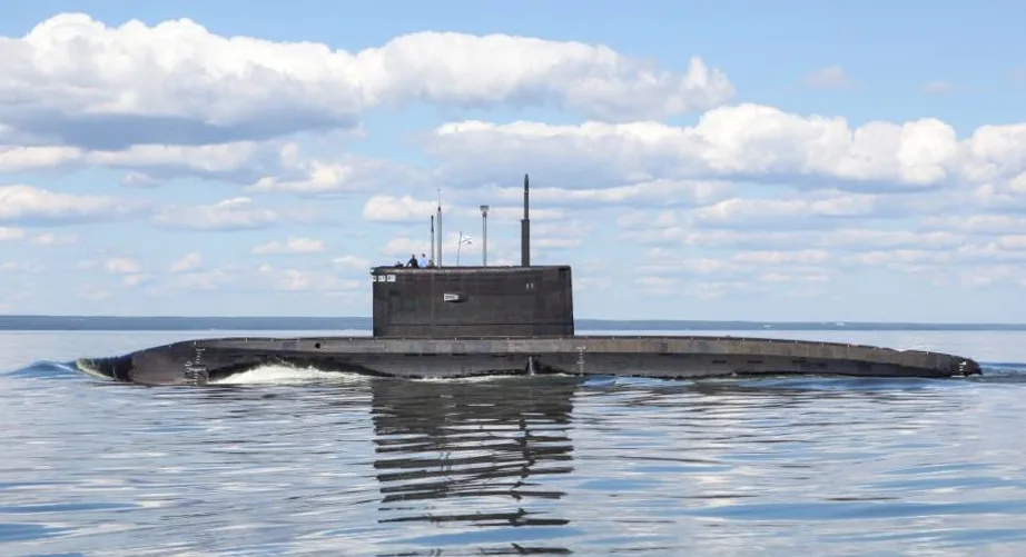 A Kilo-class diesel-electric submarine surfaced, full hull profile visible.