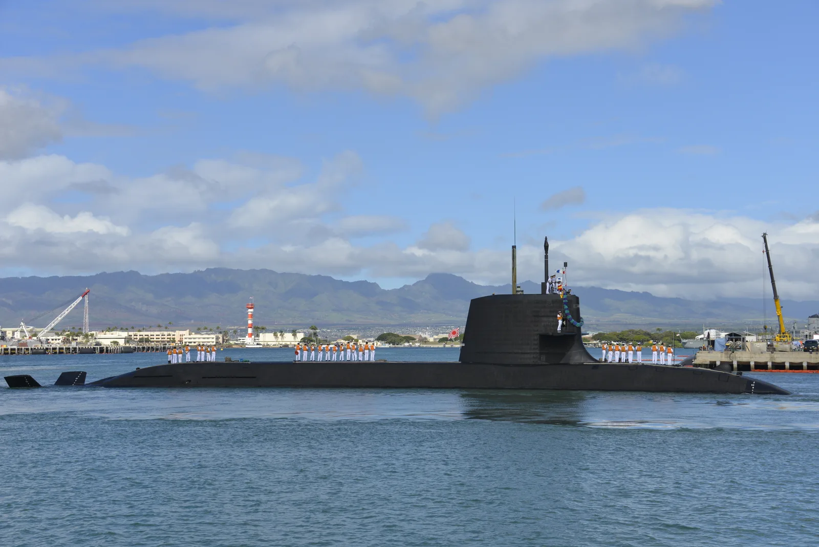 A Soryu-class submarine surfaced, full hull visible with sail and diving planes.
