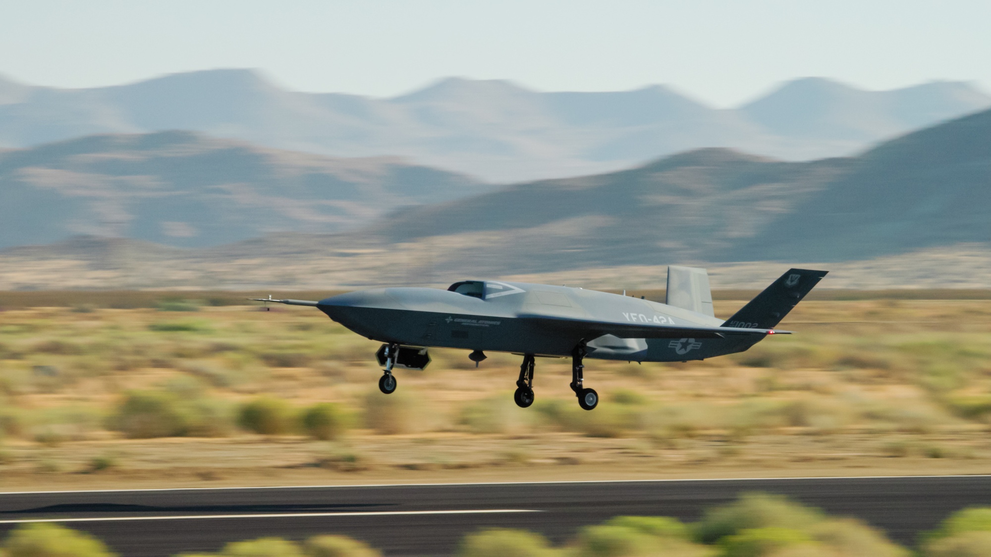 A YFQ-42A Collaborative Combat Aircraft drone, developed by General Atomics, takes off from a runway during flight testing at a California test location