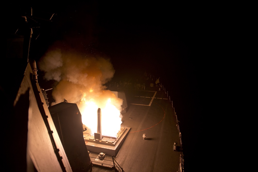 USS Arleigh Burke destroyer launching Tomahawk cruise missiles from its deck-mounted vertical launch system