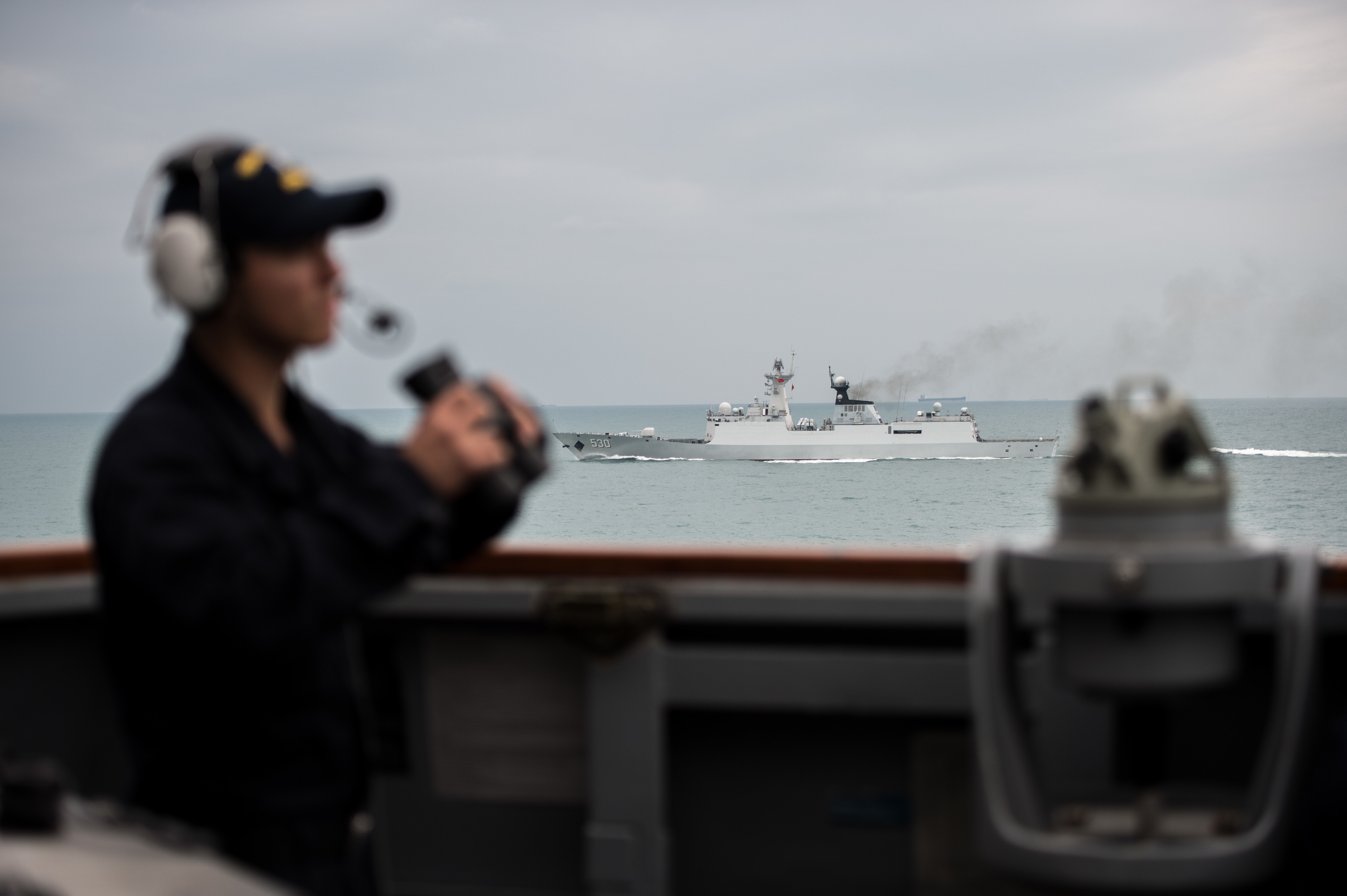 A Chinese Type 054A-class frigate operating alongside a U.S. Navy destroyer during a multinational exercise