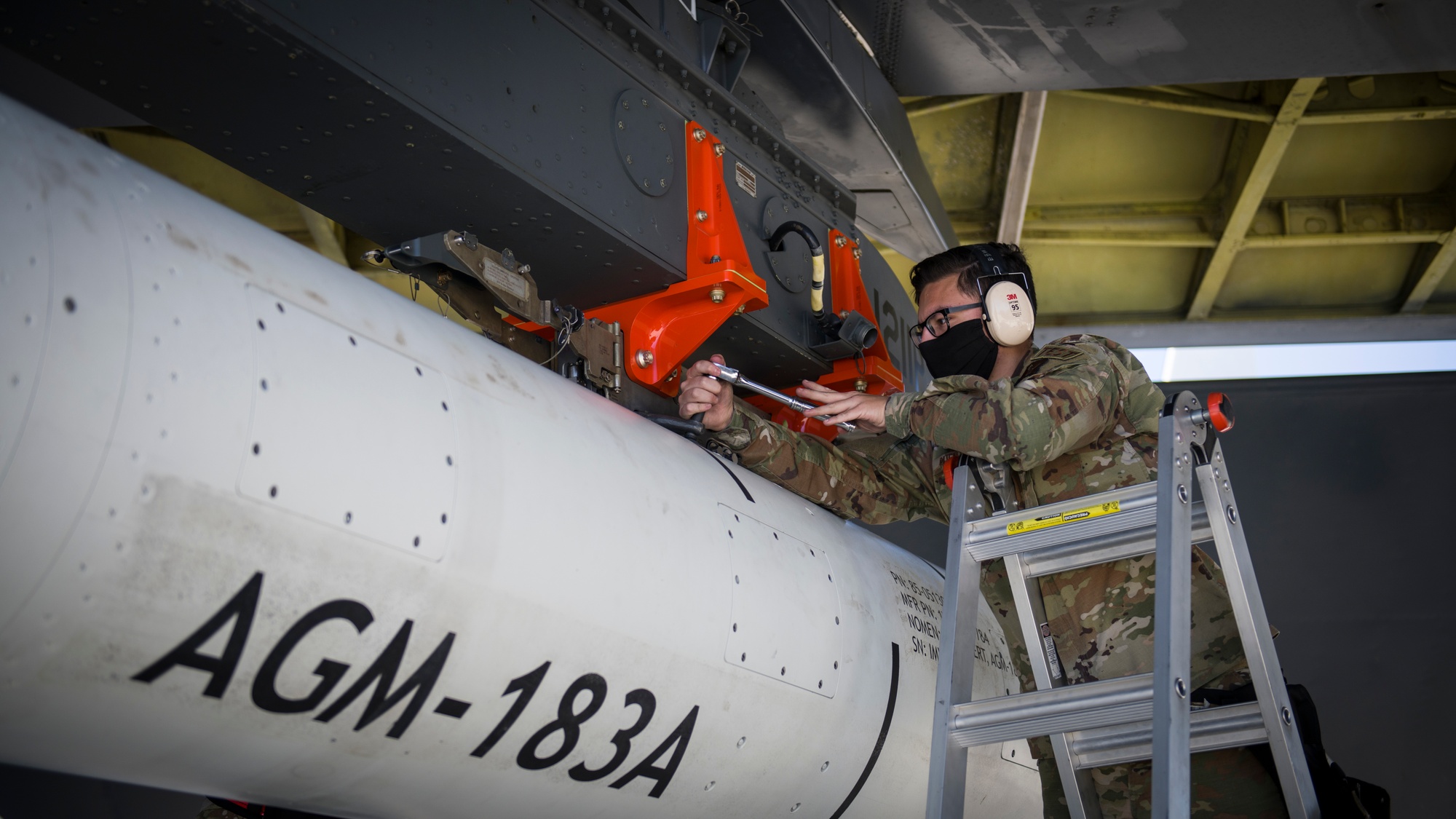 An AGM-183A ARRW hypersonic weapon mounted under the wing of a B-52 bomber during a captive-carry flight test