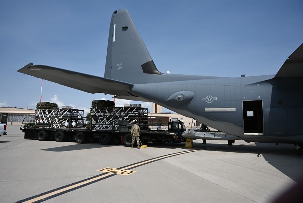 U.S. Air Force personnel load a Rapid Dragon palletized munition deployment system onto an MC-130J aircraft ahead of an airdrop test