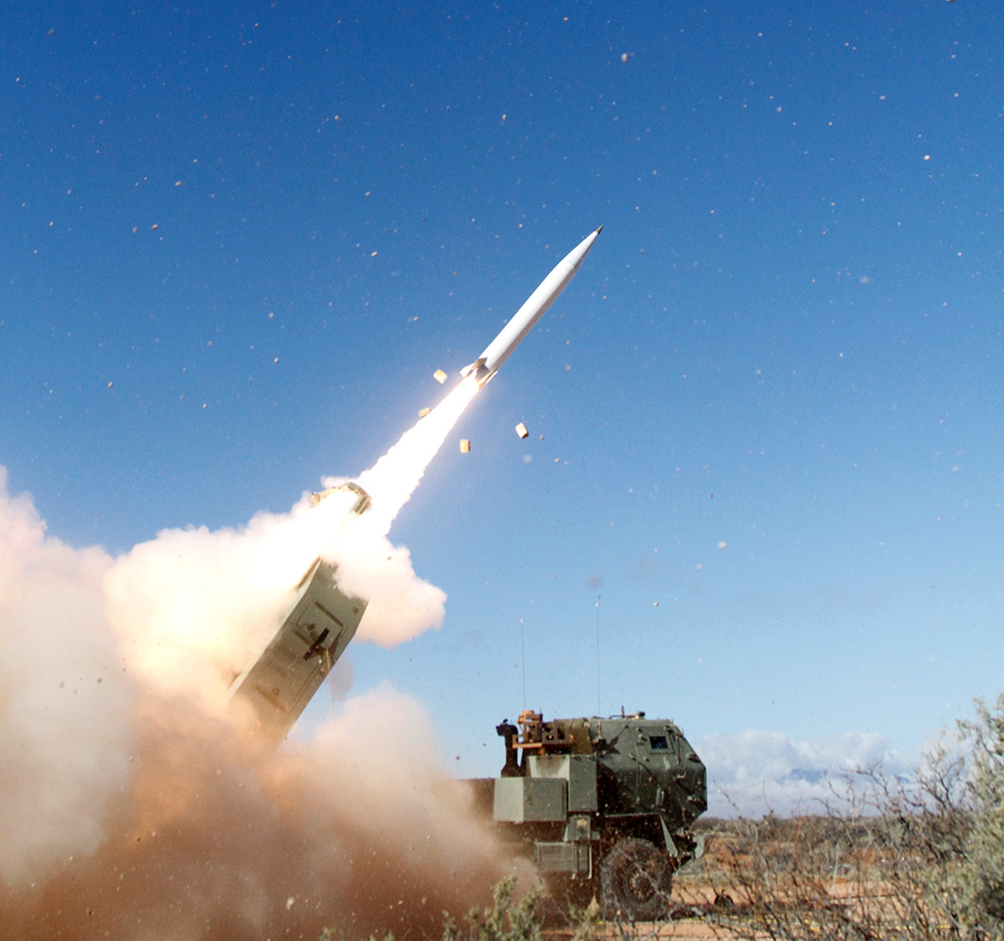 A Precision Strike Missile launches from a mobile rocket-artillery launcher during a test at White Sands Missile Range, New Mexico, leaving a bright exhaust trail