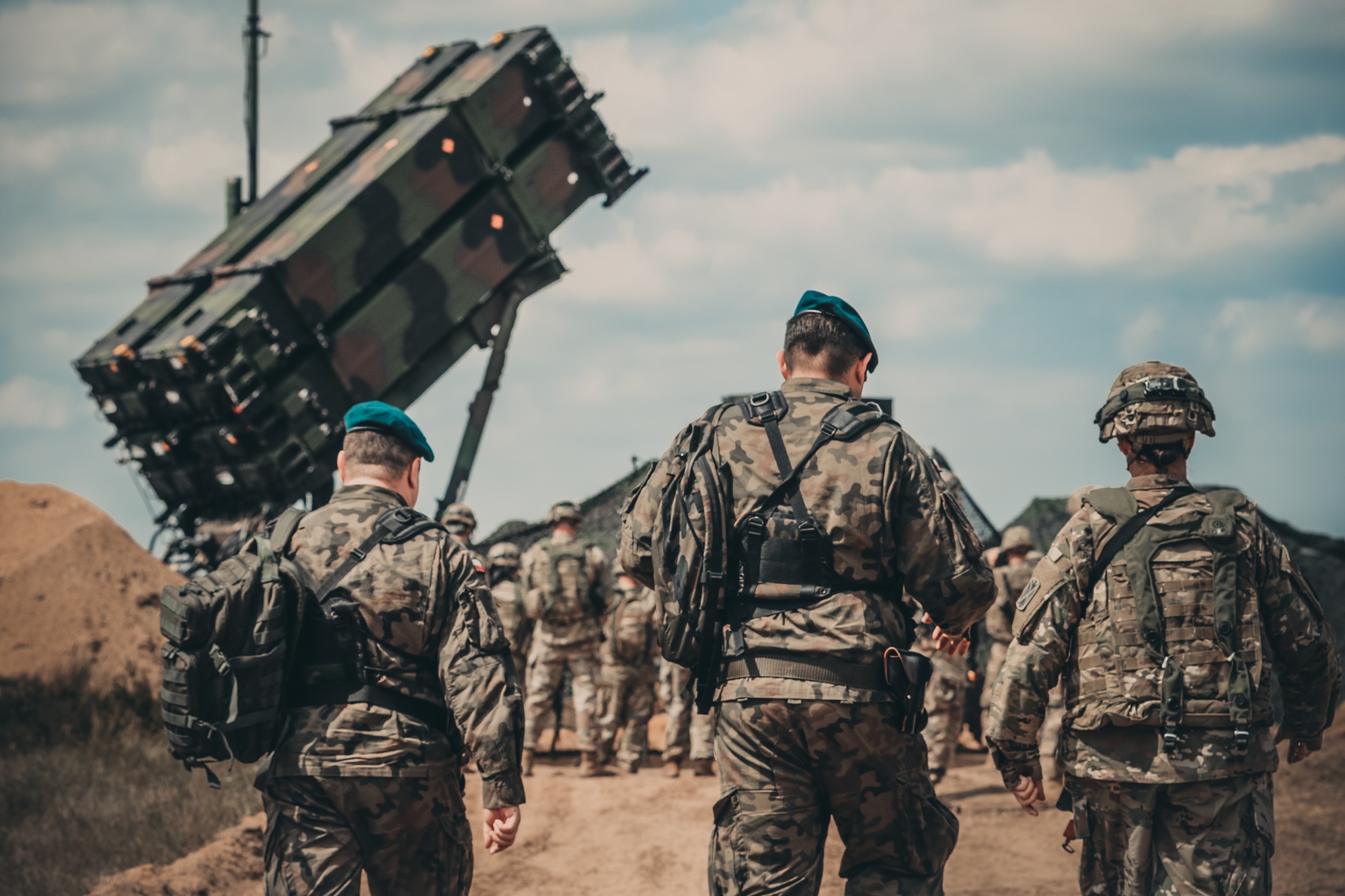 US soldiers and Polish Army personnel around a Patriot missile launcher during a field demonstration in Poland