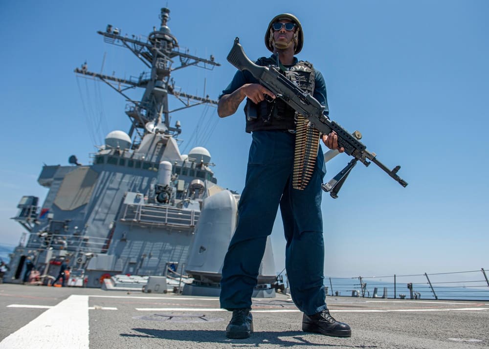 A sailor aboard the Arleigh Burke-class destroyer USS Paul Hamilton stands watch while the ship transits the Strait of Hormuz