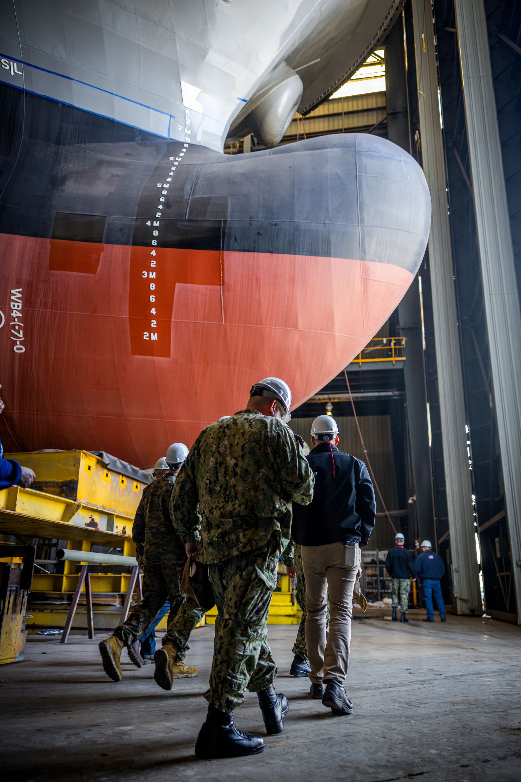 U.S. service members and Austal USA employees tour Austal's shipbuilding facilities in Mobile, Alabama