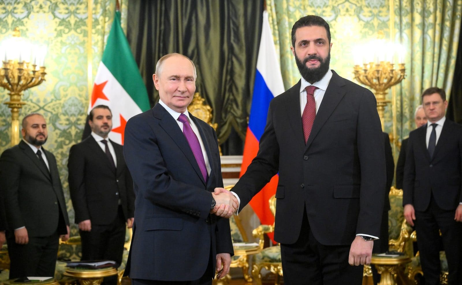 Russian President Vladimir Putin and Syrian President Ahmed al-Sharaa seated together at the Kremlin