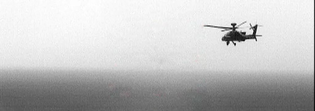 AH-64 Apache attack helicopter in flight during a training exercise